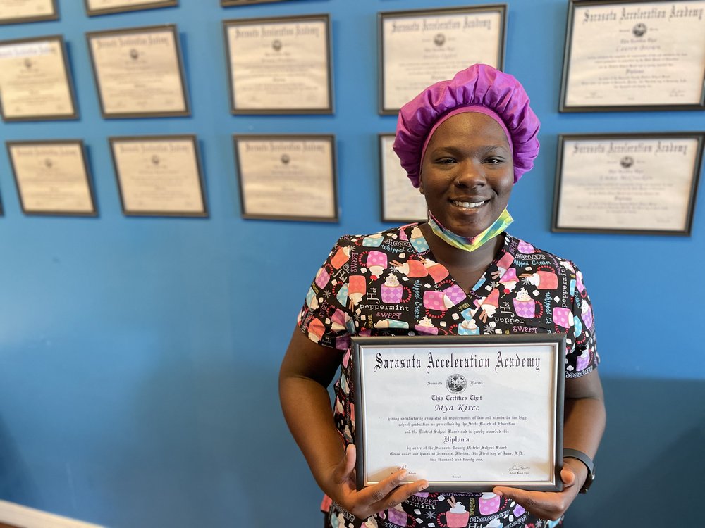 Sarasota Acceleration Academies Graduate Mya Kirce Smiles with Diploma
