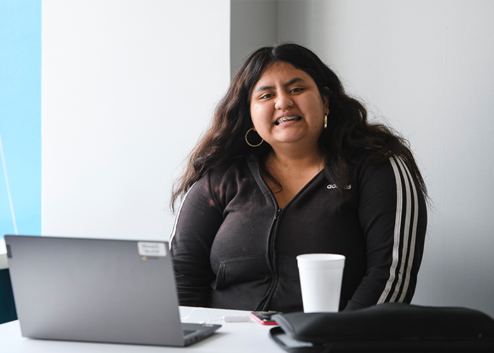 Los Angeles Student Smiling in front of computer