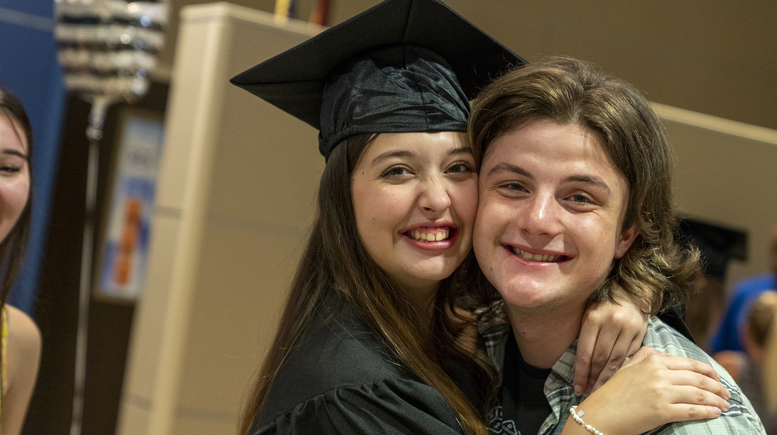 Sarasota Acceleration Academies Graduate Smiles with Friend at Graduation Ceremony