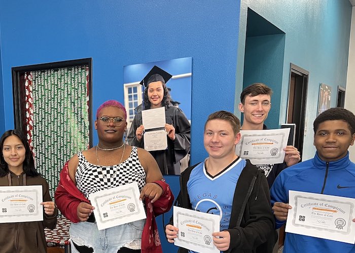 Students at Lowcountry Acceleration Academies smile and hold their certificates from the Hour of Code training experiences